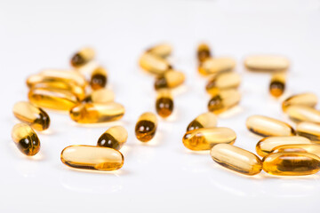 Heap of Omega 3 capsules on a white background. Top view, high resolution product. Fish fat.