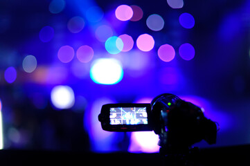 Camera filming light show at the party