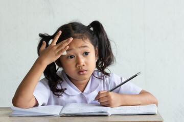 The girl sitting on the homework