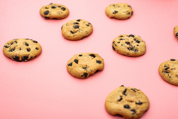 Cookies with chocolate on a pink background. Sweet background.
