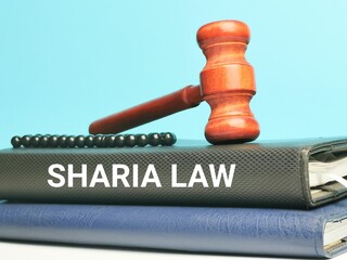 Phrase SHARIA LAW on books with gavel and prayer beads. Law concept. 