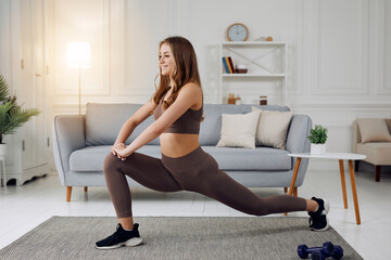 Yoga at home. Keep calm. Attractive young woman doing exercises.