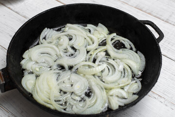 Fried onions in a pan. Cooking ingredient.