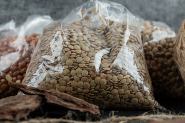 Pocket of raw lentils on marble background