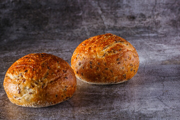 Assortment of baked bread on wooden table background Fresh fragrant bread on the table. Food concept.