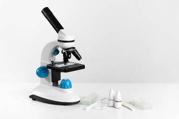 Optical microscope in a white laboratory on the table.