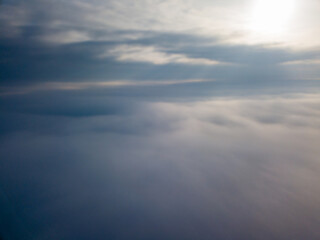 Fototapeta na wymiar Flight high above the clouds. Aerial drone view.