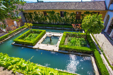 Pool,  nature,   palace of 14th century  in Generalife  gardens - part of Alhambra in  Granada.  Idyllic  springtime  holiday in Andalusia! - obrazy, fototapety, plakaty