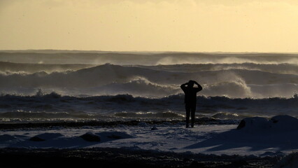 person enjoying the sunset by the atlantic ocean in iceland