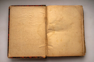An old book with pages yellowed with age on white isolate