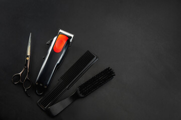 Barber shop equipment set isolated on black table background. Close up sccissors, comb, brushes, razors, professional tools of hairdresser. Professional occupation, art, self-care concept. Magazine.
