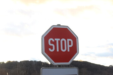red stop sign in traffic