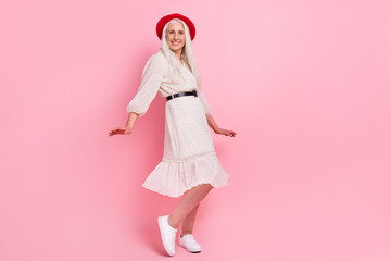 Full length body size view of attractive cheerful grey-haired granny dancing having fun isolated over pink pastel color background