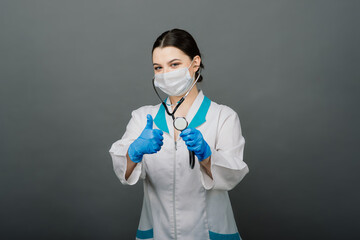 Beautiful female doctor in mask looking away and thinking about something.