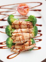 Food photo. Stir-fried chicken with oyster sauce. In a white plate.