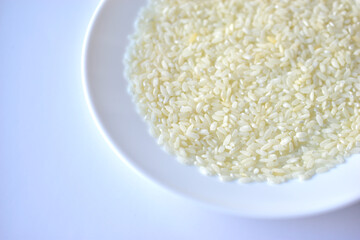 White yellow rice grains on a white plate