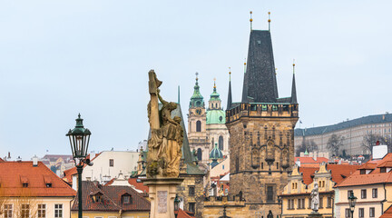 Prague, Czech Republic-February 02, 2019. View of the buildings tops and the Lesser Town Bridge Tower of the famous historical Charles bridge at old part of Prague town.