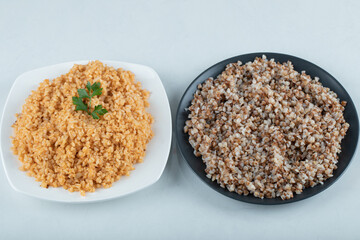 Delicious bulgur and buckwheat on a plates