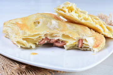 Freshly baked bakery displayed on white wooden background