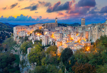Panoramic of Sorano in the evening sunset with old tradition buildings and illumination. Tuscany,...