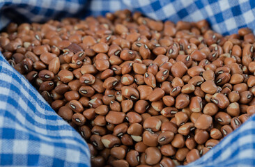 Pile of red beans on striped tablecloth