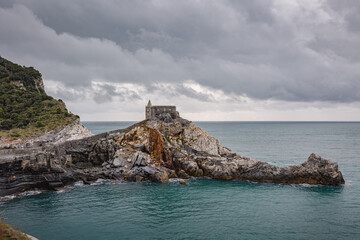 Portovenere (Porto Venere) in Liguria, Italy: beautiful aerial scenic view of the Church of St....