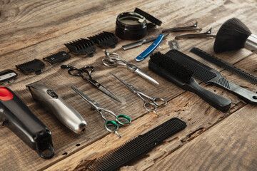 Barber shop equipment set isolated on wooden table background. Close up sccissors, comb, brushes, razors, professional tools of hairdresser. Professional occupation, art, self-care concept. Magazine.