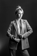 Sexy young blonde, a jacket dressed on a naked body. The model is looking to the side.