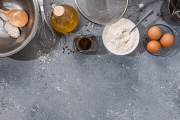 Set of kitchen utensils with products on gray-blue background. Cooking master classes. Copy space.