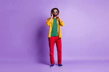 Full length photo of positive dark skin person hands touch headphones isolated on magenta color background