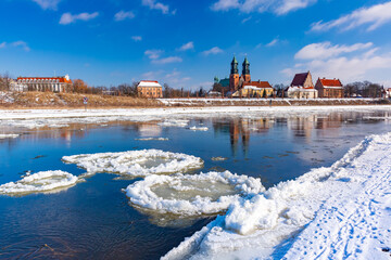 Poznan Cathedral and ice drift on Warta River in the winter sunny day, Poznan, Poland