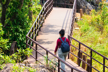 Tourists walking on the nature trail at Chae Son National Park Lampang Thailand.