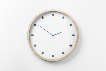 Time is coming concept with white round wall clock in light wooden frame, 2.51pm