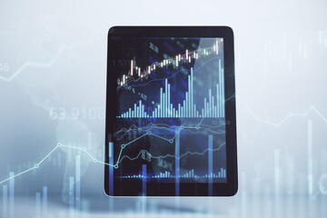 Stock market investment concept with financial chart on digital tablet screen and abstract transparent forex graphs and lines. Double exposure