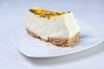Yellow colorful passion fruit fluffy dessert on white wooden background