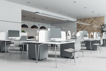 Fototapeta na wymiar Sunny open space office with light grey furniture, wooden wall and concrete floor