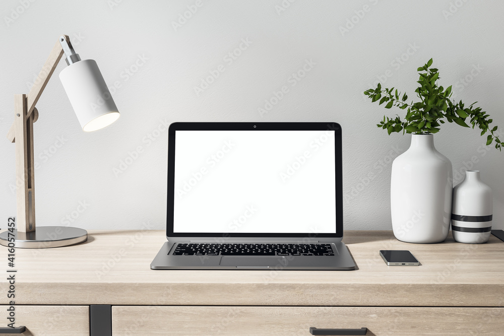 Aufkleber front view on blank white laptop monitor on wooden table with decor elements for comfortable remote 