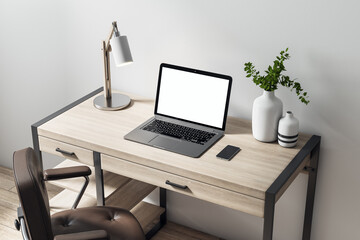 Blank white laptop screen on wooden table with modern lamp, vase and leather chair on the floor. Home office concept. Mock up