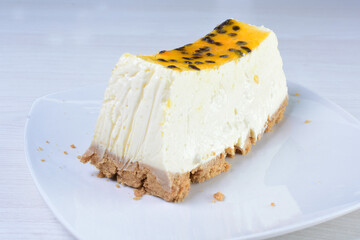 Yellow colorful passion fruit fluffy dessert on white wooden background