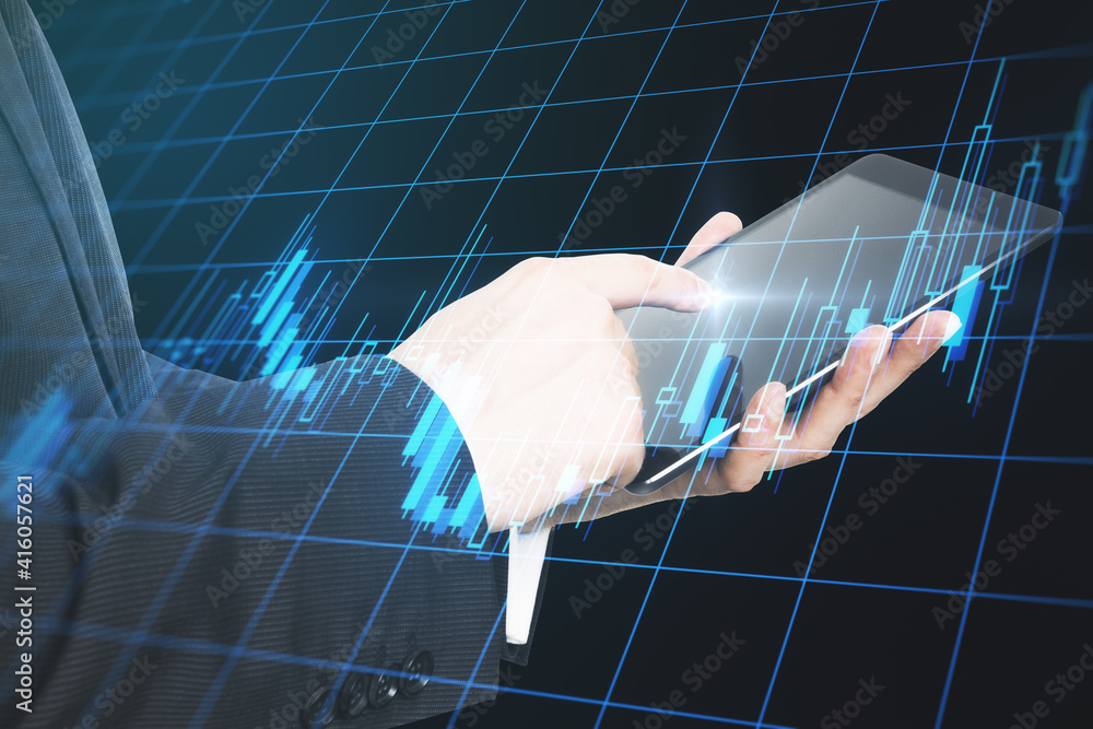 Poster Online investment concept with businessman hand using digital tablet and digital display with glowing financial graphs