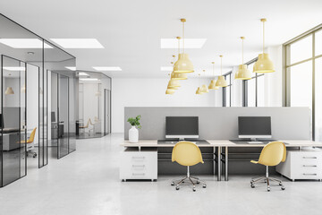 Modern open space office with light grey furniture, yellow lights and chairs, concrete floor and...