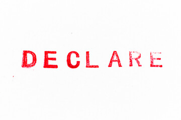 Red color ink rubber stamp in word declare on white paper background