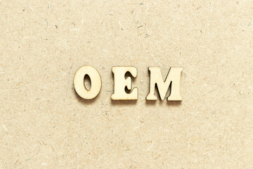 Alphabet letter in word OEM (Abbreviation of Original Equipment Manufacturer) on wood background