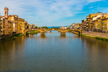 Beautiful panoramic view of the bridge Ponte Santa Trìnita spanning the Arno river in the historic city centre of Florence. The Renaissance bridge is the oldest elliptic arch bridge in the world.