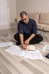 Fototapeta na wymiar Caucasian man in casual clothes calculating taxes on the tax dial to refund money