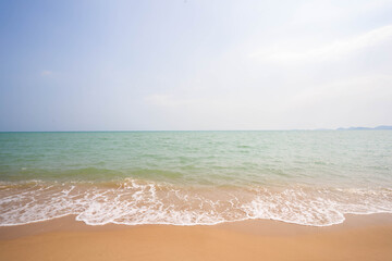 White waves on a beautiful beach, sea and blue sky, sea background.