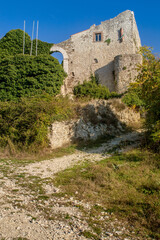Fototapeta na wymiar The medieval castle of the abandoned village of Monte Antuni in the middle of Lago del Turano, Rieti, Lazio, Italy