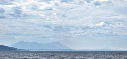 Beautiful landscape of Kuriles islands in blue haze.