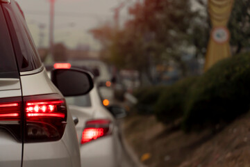 Abstract and blurred of traffic congestion of cars on roads with grass and trees.