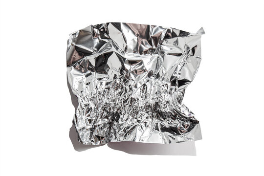 White shiny aluminum foil wrap without chocolate candy on a white background. Texture of used crumpled aluminium food foil.